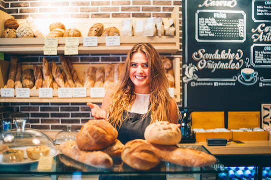 Woman sells in bakery.